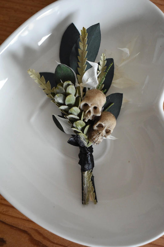 Foliage boutonniere with mini faux skulls