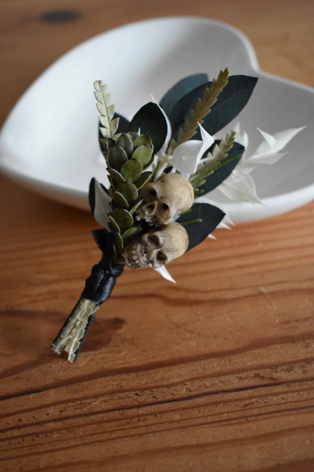 Foliage boutonniere with mini faux skulls