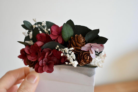 Icy burgundy hydrangea and eucalyptus winter pocket boutonniere