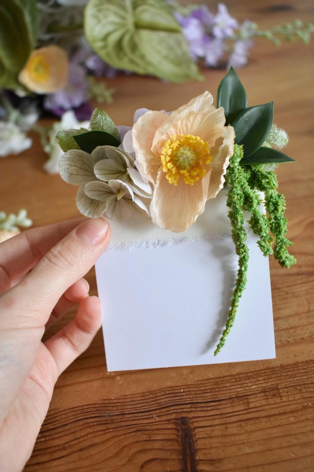 Peach poppy pocket boutonniere with trailing amaranthus