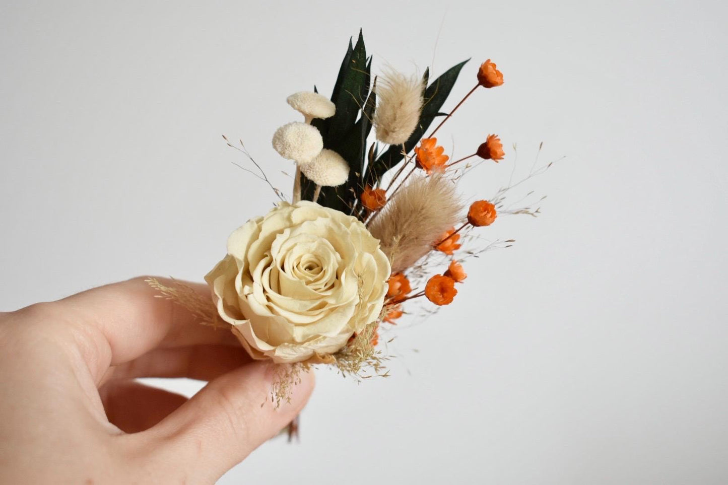 Rose boutonniere with orange glixia