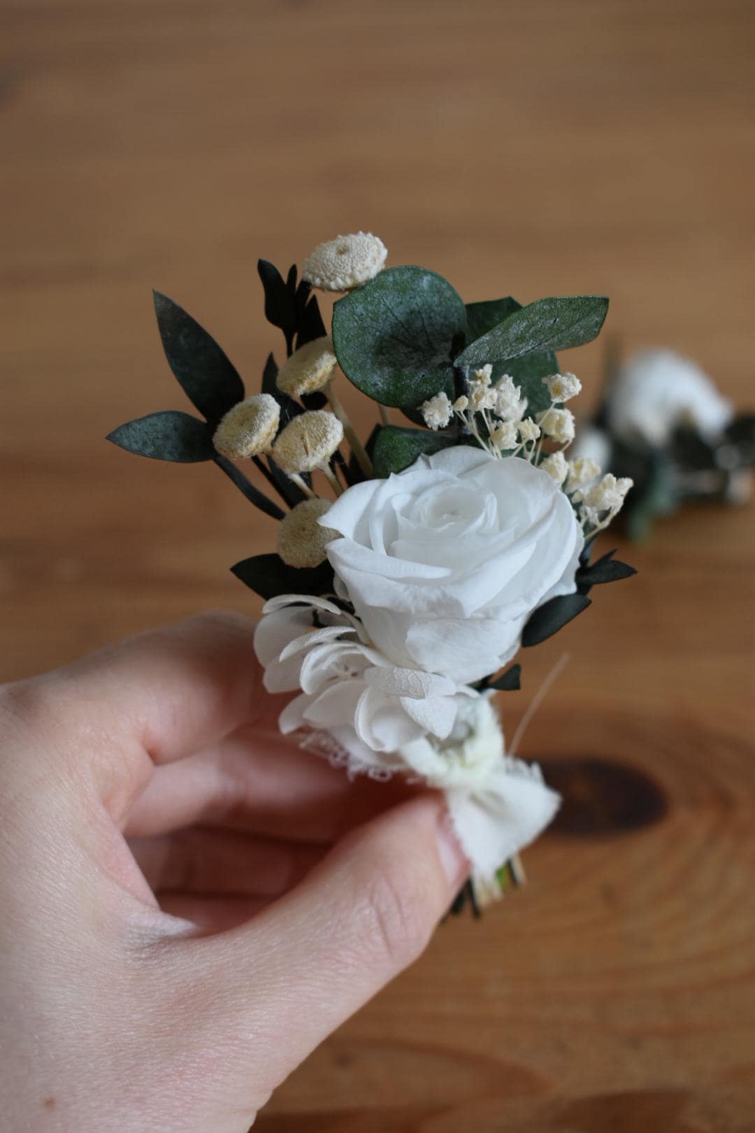 White rose and foliage boutonniere