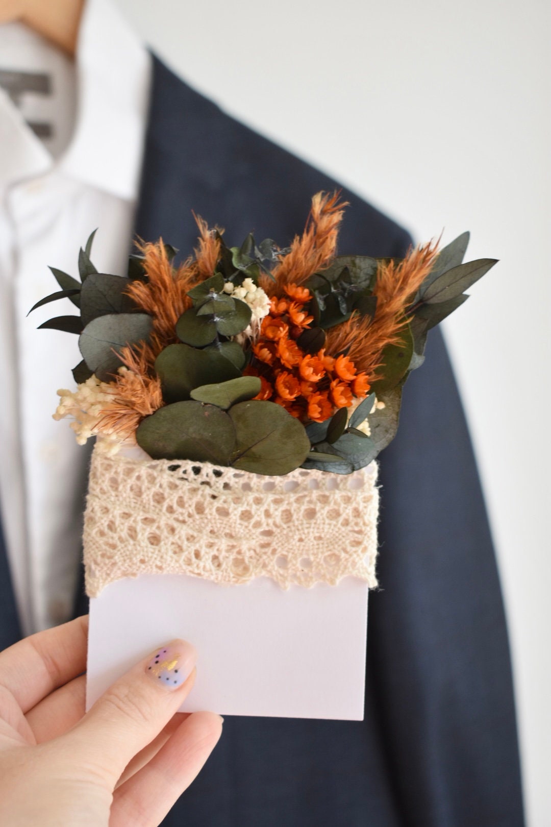 Orange pampas pocket boutonniere