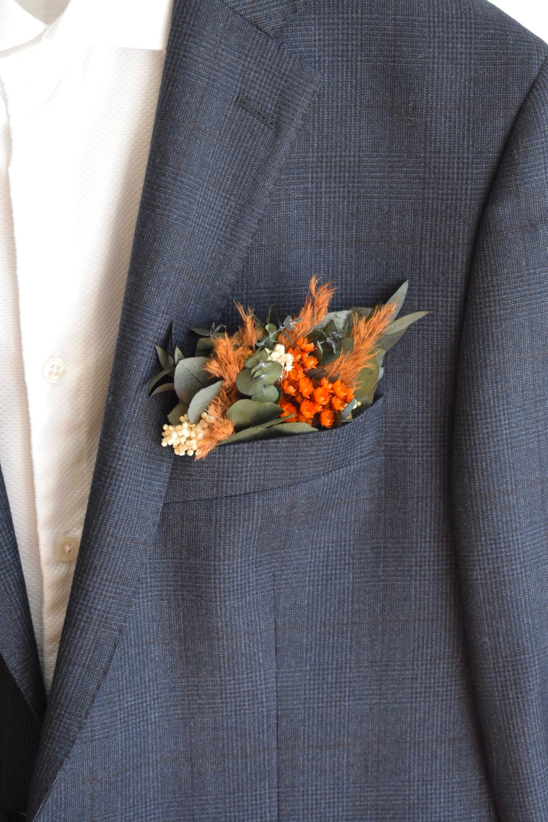 Orange pampas pocket boutonniere