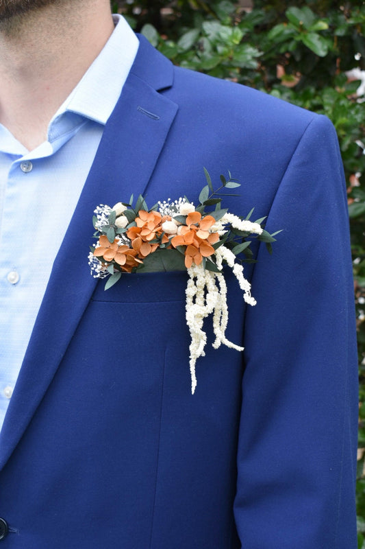 Orange hydrangea, eucalyptus and cascading amaranthus pocket boutonniere