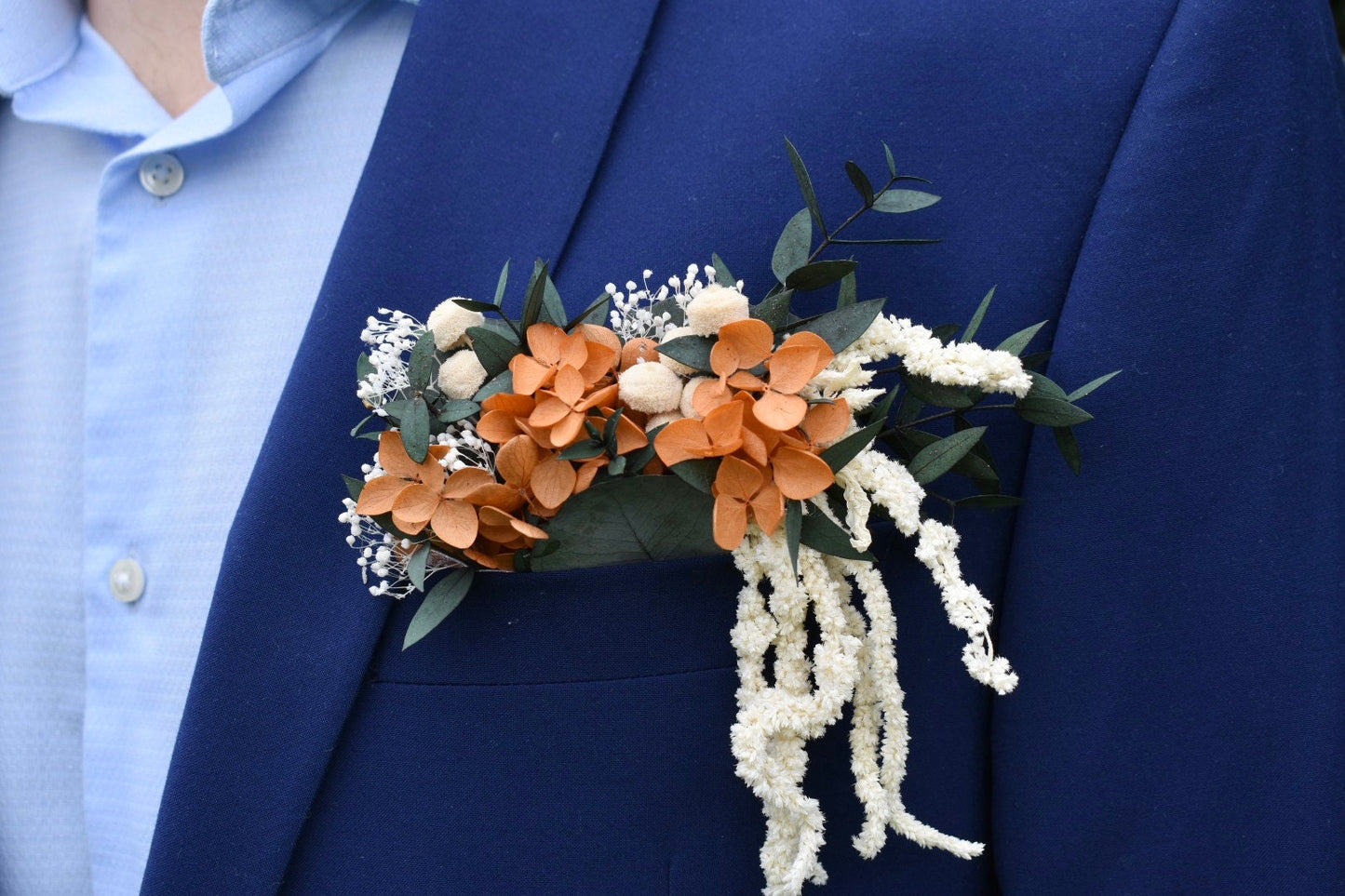 Orange hydrangea, eucalyptus and cascading amaranthus pocket boutonniere