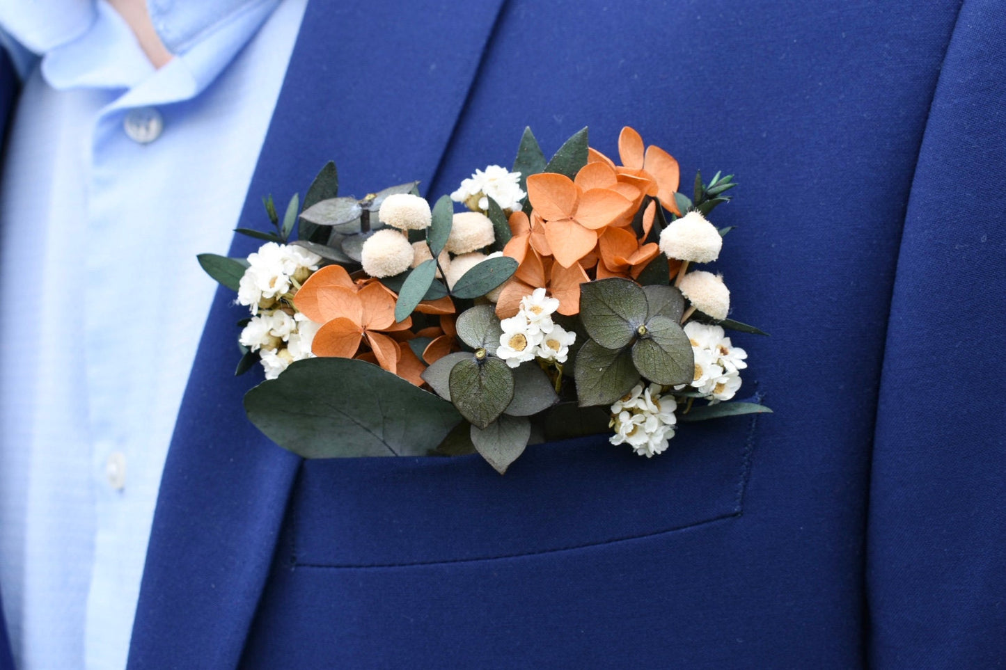Orange hydrangea and daisy pocket boutonniere
