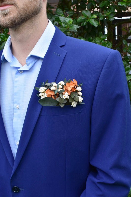 Orange hydrangea and daisy pocket boutonniere