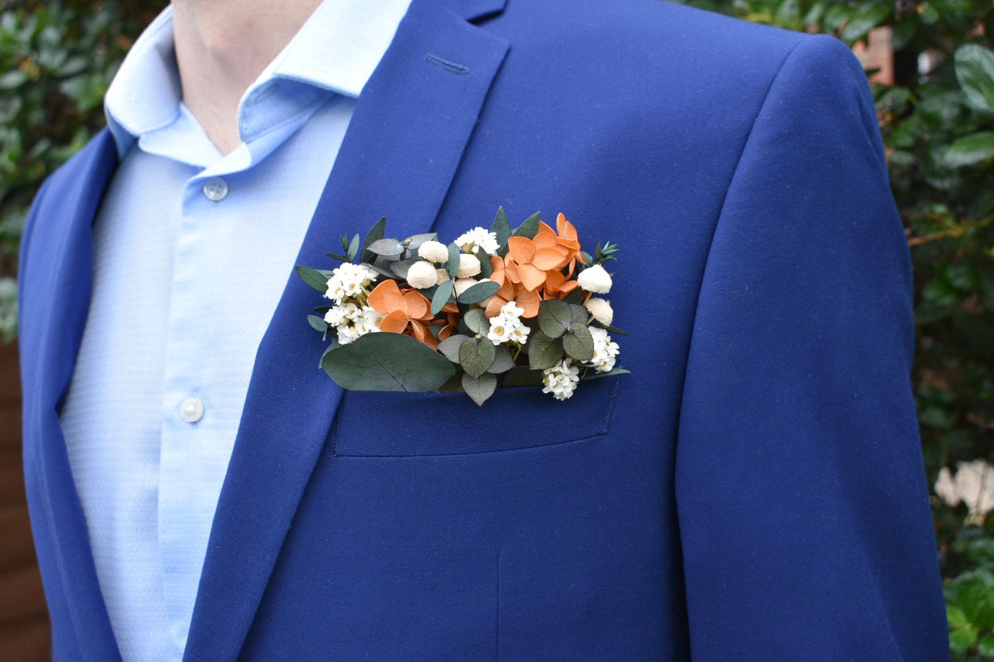 Orange hydrangea and daisy pocket boutonniere