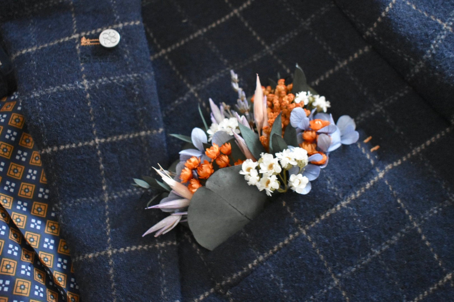 Orange, blue and lilac pocket boutonniere