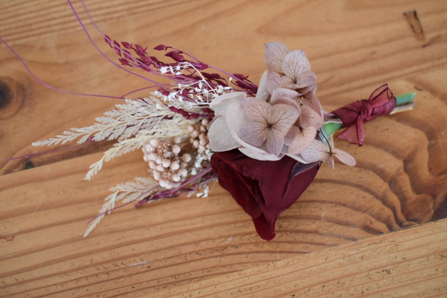 Nude, blush and red boutonniere