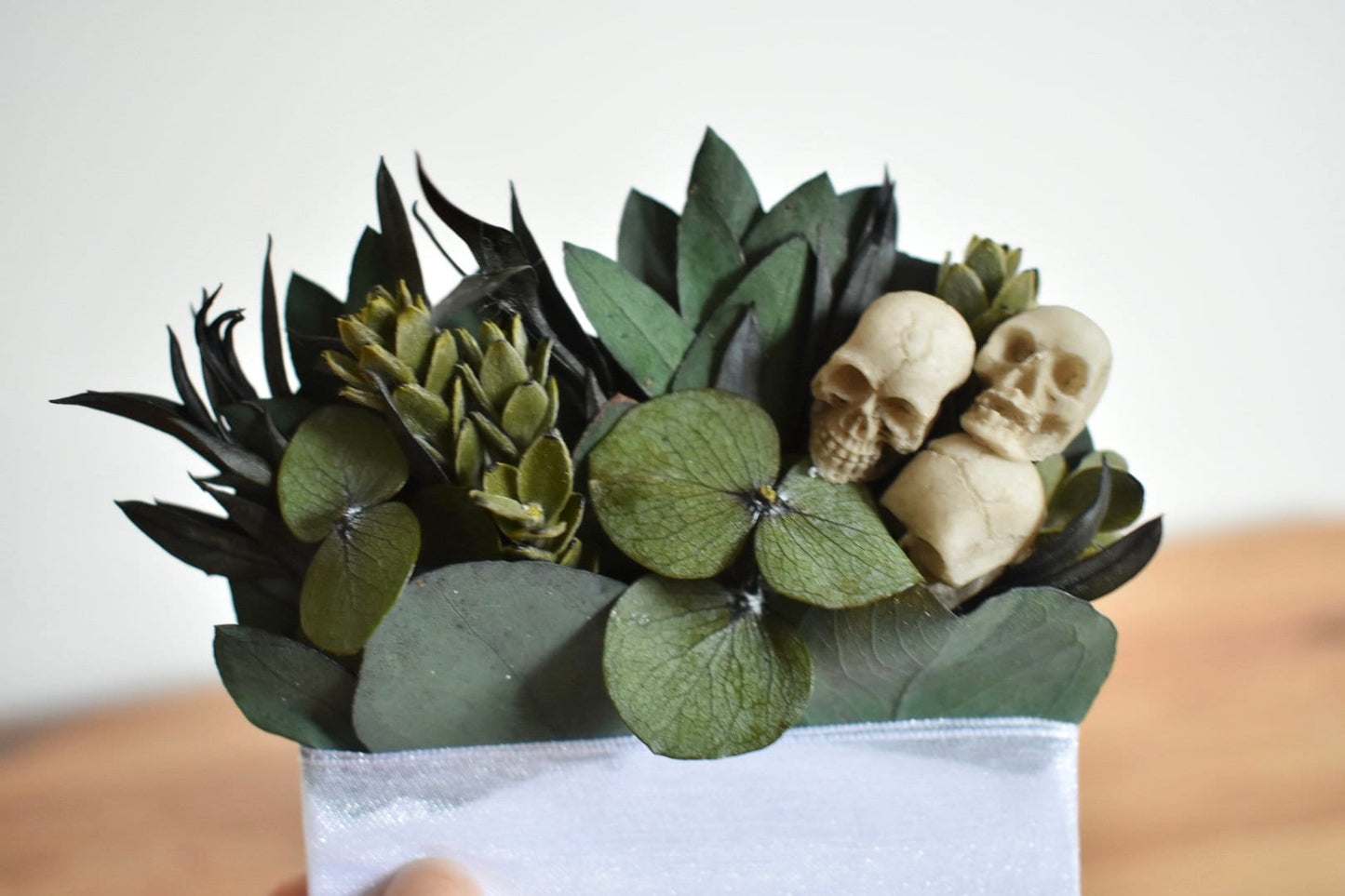 Pocket boutonniere with skulls and preserved greenery