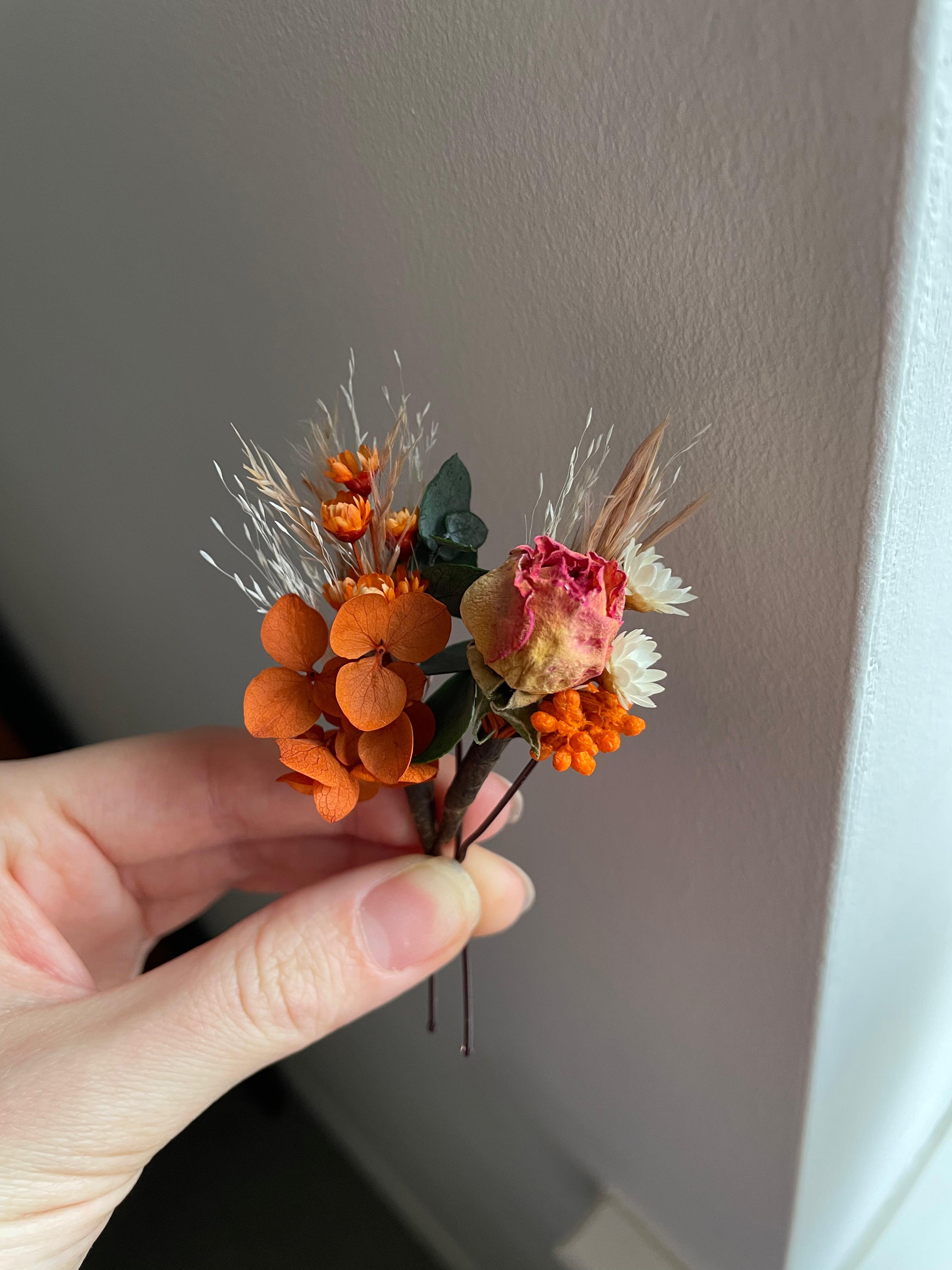 Hair pins made with dried flowers in orange and neutrals. Handcrafted in Derbyshire 