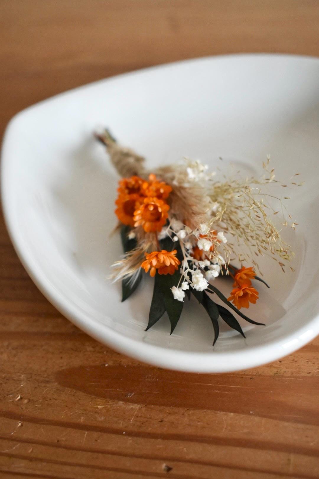 Orange dried flower boutonniere