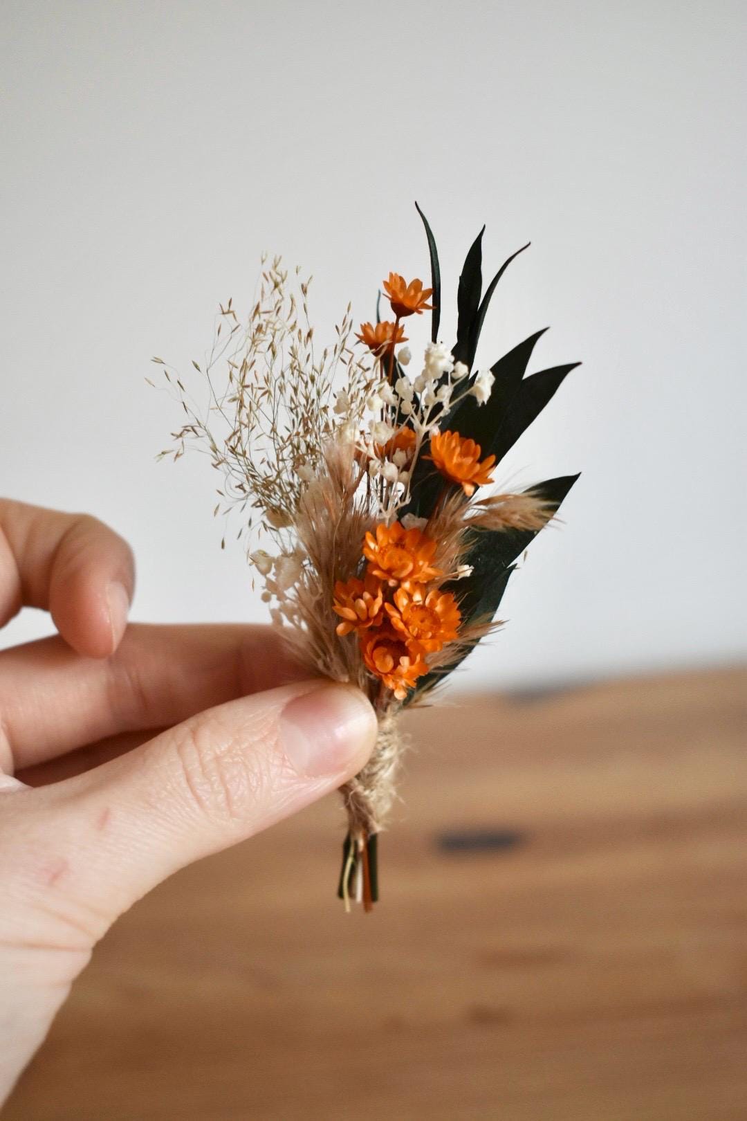Orange dried flower boutonniere