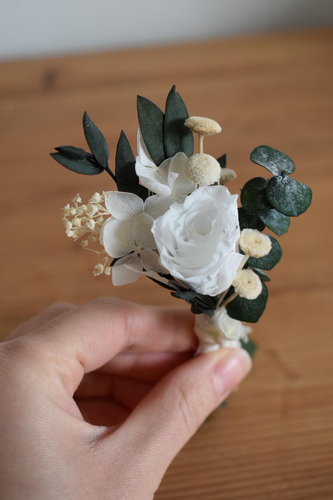 White rose and foliage boutonniere