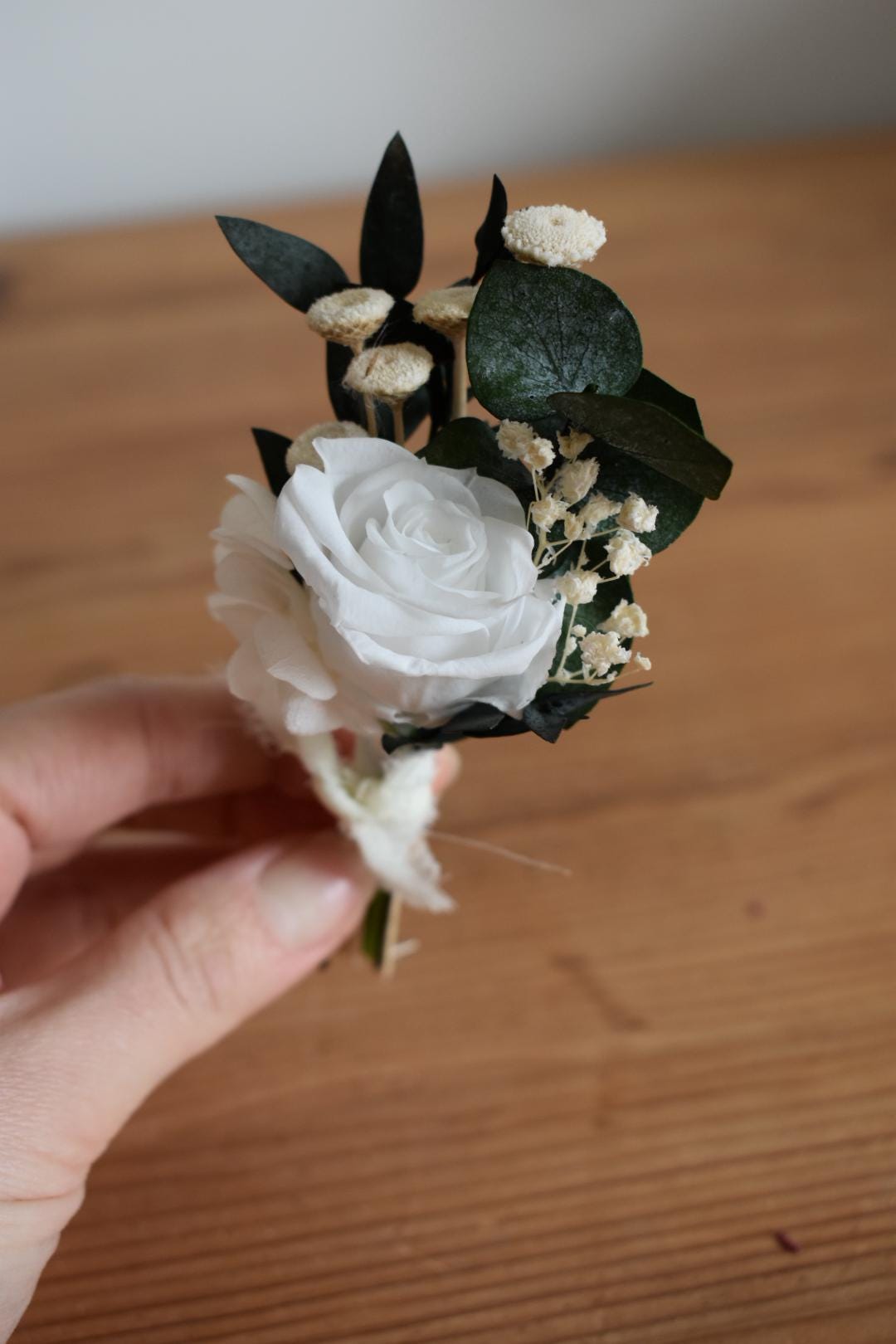 White rose and foliage boutonniere