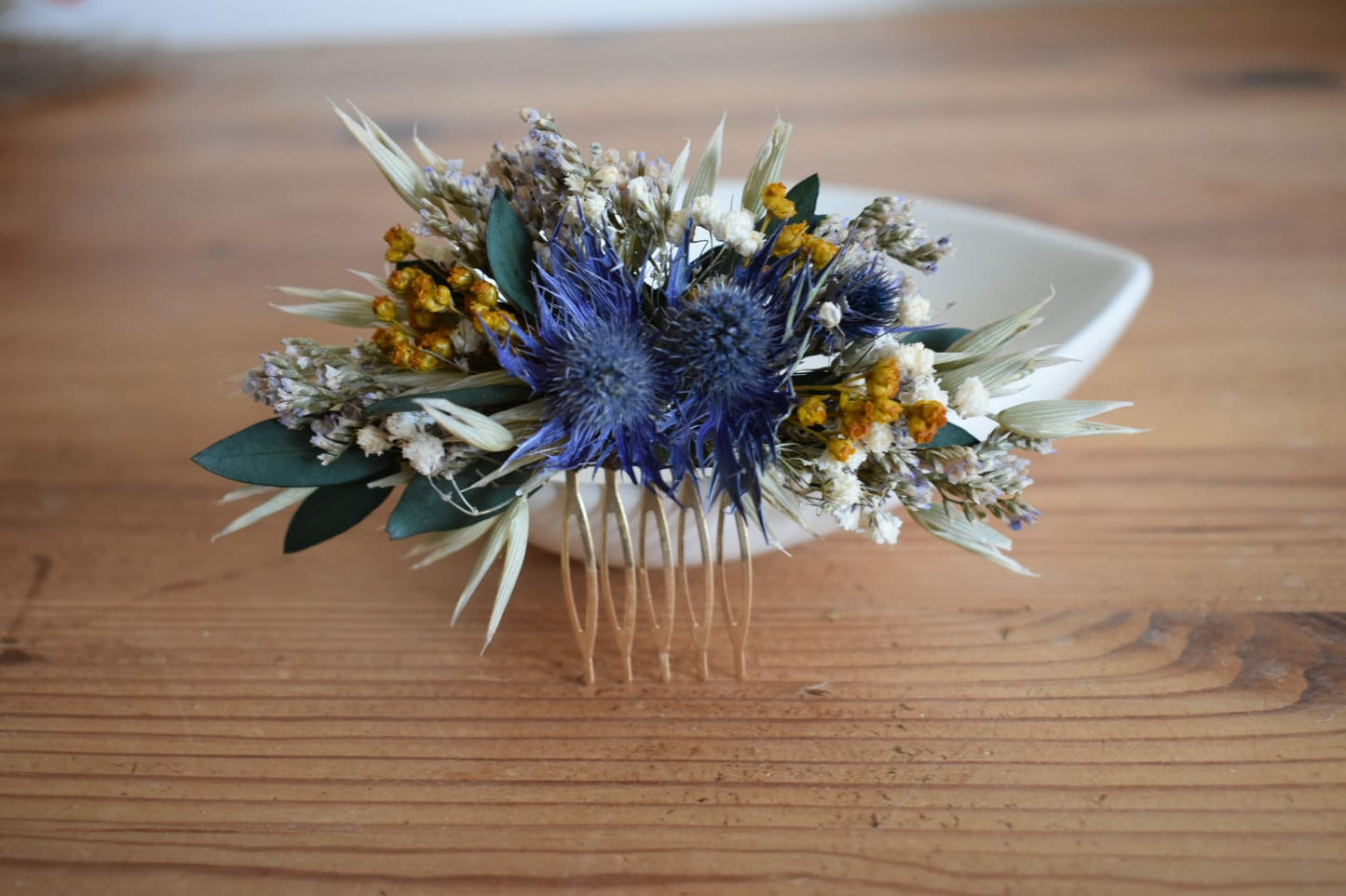 Blue thistle and mustard yellow flower comb